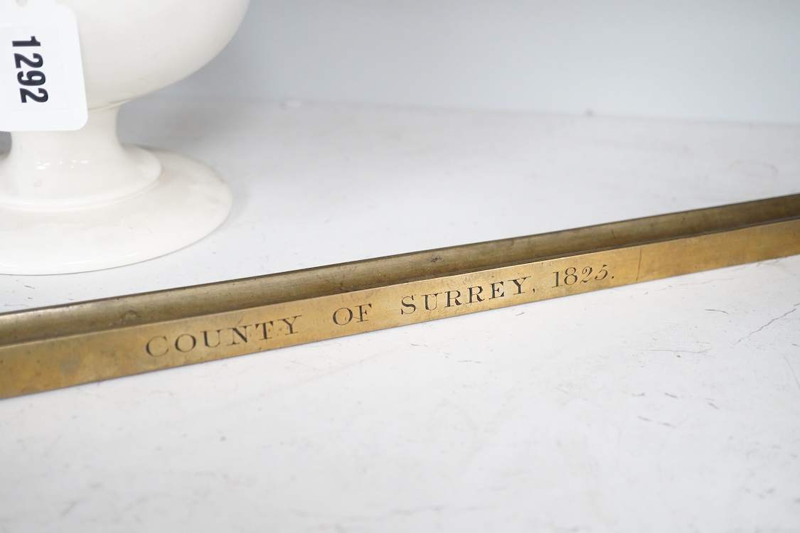 A George IV Imperial brass yard stick, engraved with County of Surrey 1825, with official stamps and crowned VR, etc.
